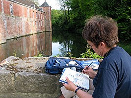 The water colourist painting in the nature.