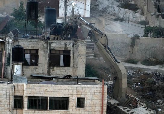 Image for story: Israeli soldiers pushed 3 apparently lifeless bodies from roofs during a West Bank raid