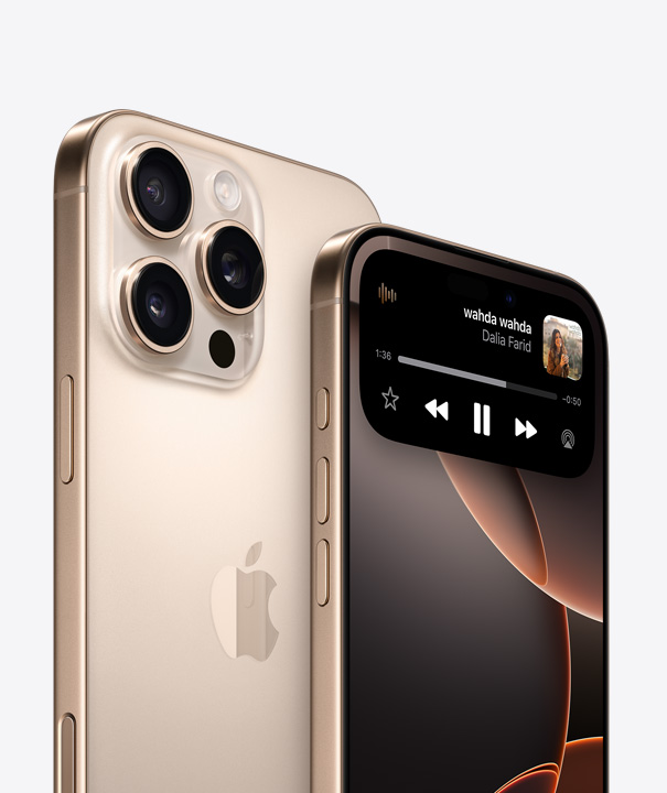 Back of iPhone 16 Pro in White Titanium showing three camera lenses behind another iPhone Pro highlighting Dynamic Island on display screen.