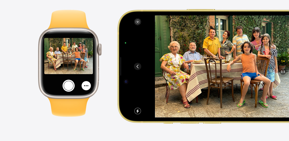 Un iPhone 15 făcând o fotografie. Un Apple Watch Series 9 folosește funcția Telecomandă cameră pentru a vedea fotografia făcută pe iPhone 15.