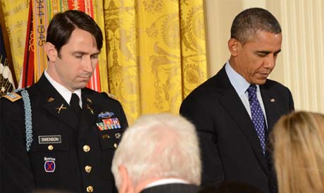 Former Army Capt. William D. Swenson and President Barack Obama bow their heads before the Medal of Honor ceremony at the East Room of the White House in Washington, D.C., on October 15, 2013. (Photo Credit: U.S. Army)