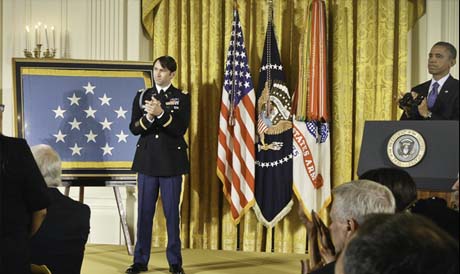 President Barack Obama and Medal of Honor recipient Capt. William D. Swenson applaud friends and families of his fallen comrades during his ceremony at the White House in Washington, D.C., Oct. 15, 2013. Former U.S. Army Capt. William D. Swenson was leading a group of Afghan Border Police in support of the 1st Battalion, 32nd Infantry Regiment, 3rd Brigade Combat Team, 10th Mountain Division at the time of the battle. (U.S. Army photo by Sgt. Garry McFadden)