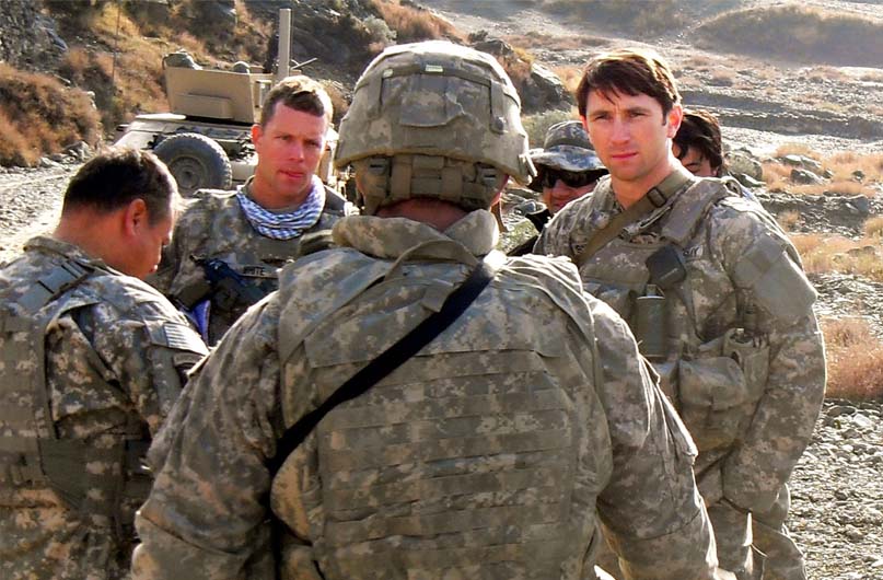 Capt. William D. Swenson (far right) talks with Soldiers while in support of the 10th Mountain Division (Light Infantry) in Afghanistan. Swenson served as an embedded trainer and mentor for the Afghan Border Police. 