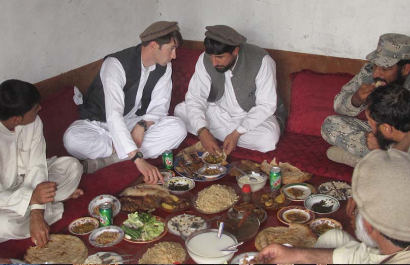 Capt. William Swenson has lunch with Afghan National Army local leadership and former Mujahadeen outside of Asadabad, Afghanistan, March 2009.