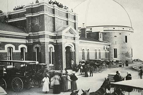 Historic black and white photo of an observatory with domed roof.