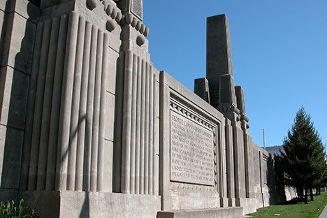 Bold wall of series of columns with text carved into a section.