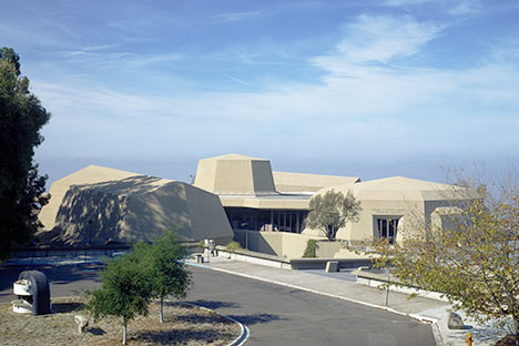 Polygon buildings with roadway and blue sky