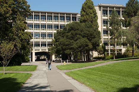 Large building with breezeway in center with people walking