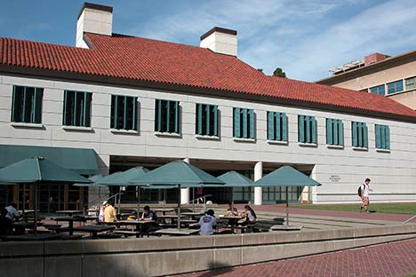 Red tiled building with area in front for tables and umbrellas