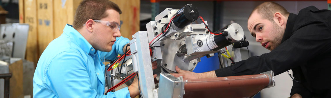 males students working with a robot