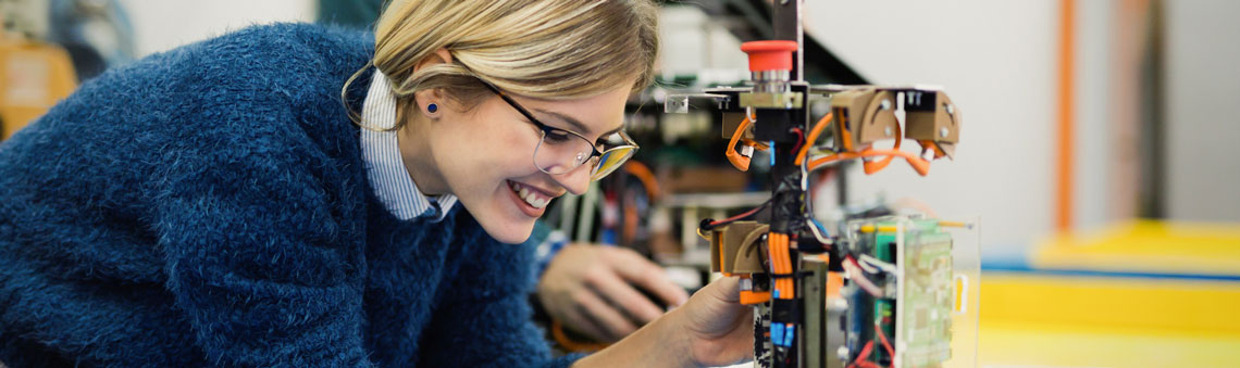 Female student working on integrated electronics project