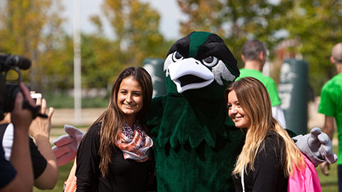 Students taking a photo with mascot