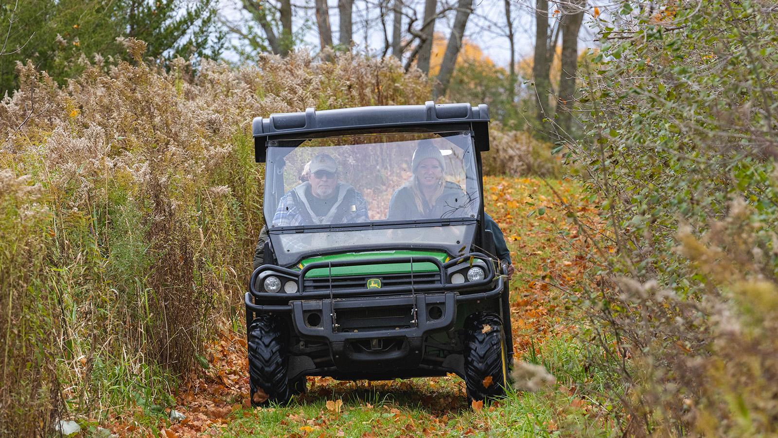 Riders in a side by side on a trail