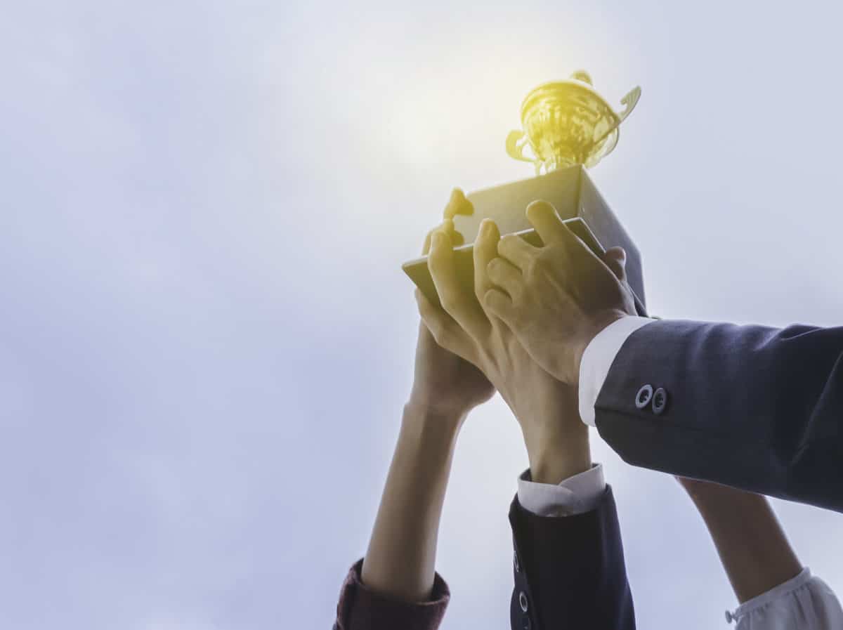 People holding up a trophy