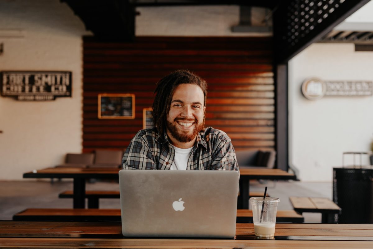 man using laptop smiling