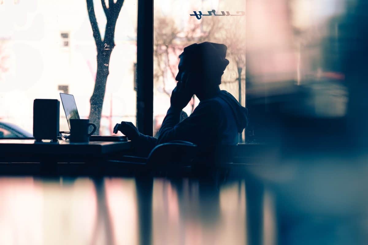 silhouette image of a person using a laptop,