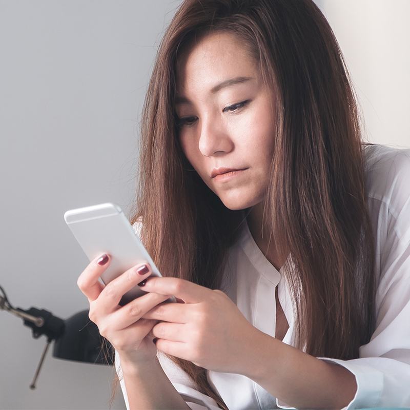 A woman looking at her smartphone