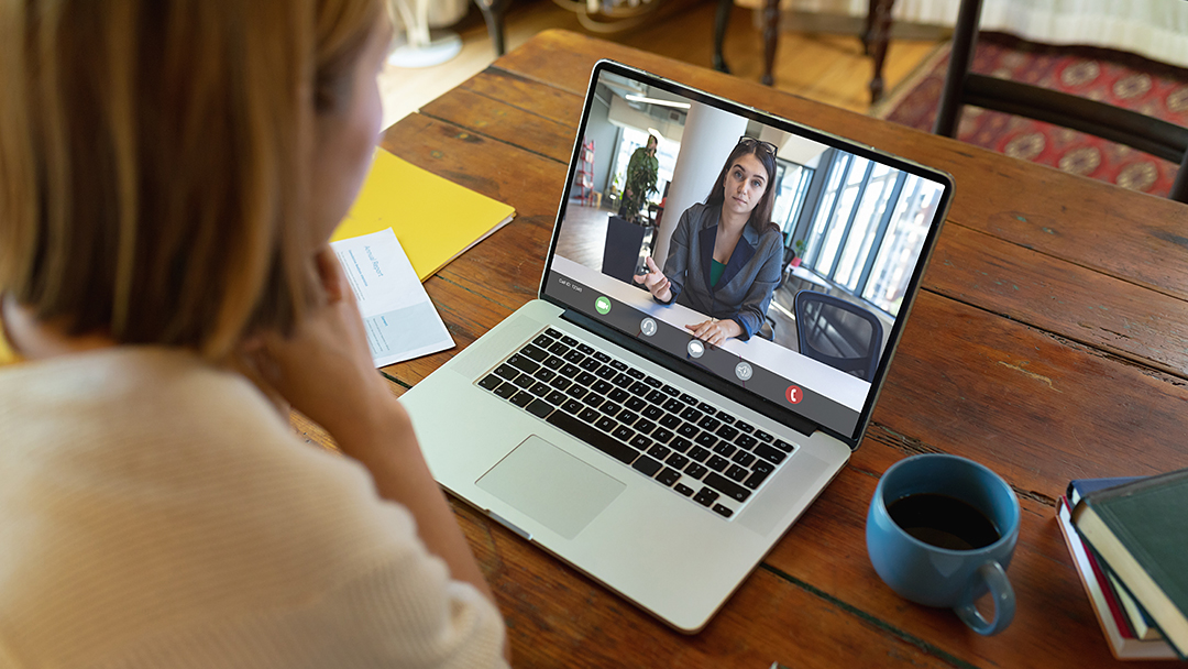 Student having a virtual meeting on a laptop with a career counselor