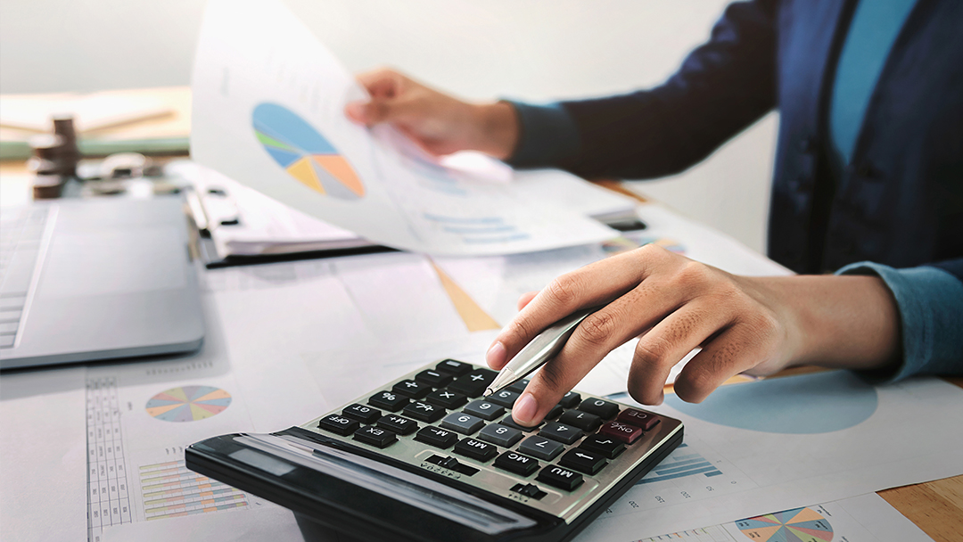 Accountant reviewing documents and using a calculator